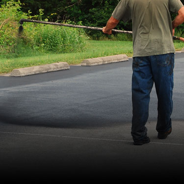 Sealcoating being applied to a driveway