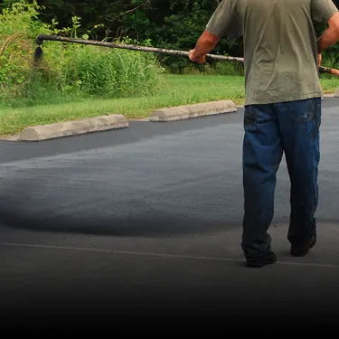 Sealcoating being applied to a driveway